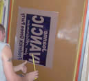 Placing the sign separation on the coated screens.  Next they go to the vacuum frame.